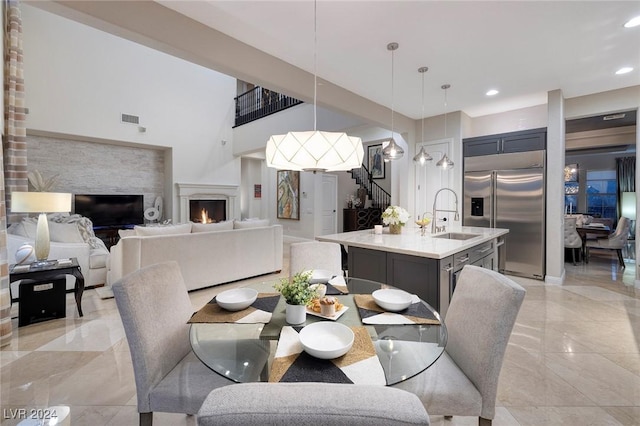 dining space with a towering ceiling and sink