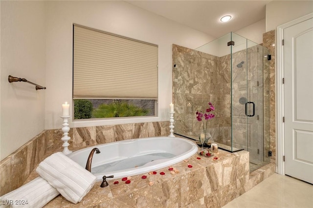 bathroom with tile patterned flooring and shower with separate bathtub