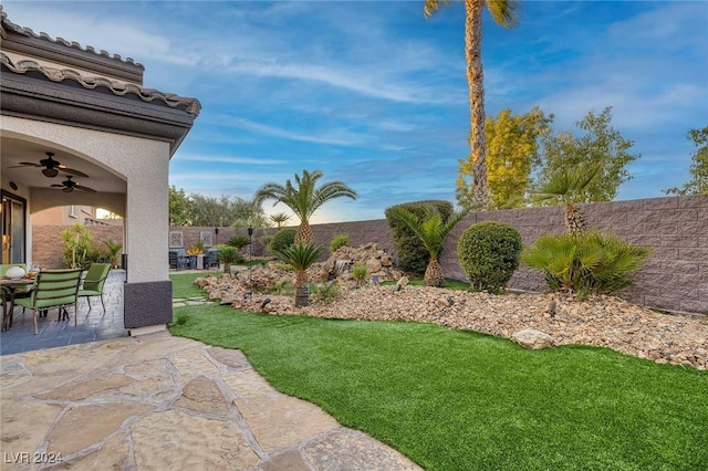 view of yard featuring ceiling fan and a patio area