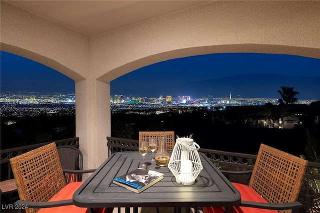 2781 Josephine Dr, Henderson, NV 89044 - balcony at twilight with outdoor dining area and a view of city lights