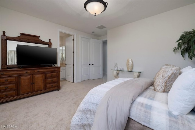 carpeted bedroom featuring ensuite bath