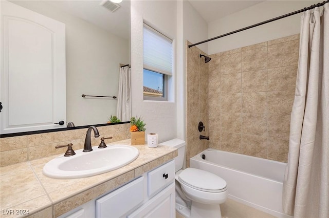 full bathroom featuring vanity, shower / bath combo, and toilet