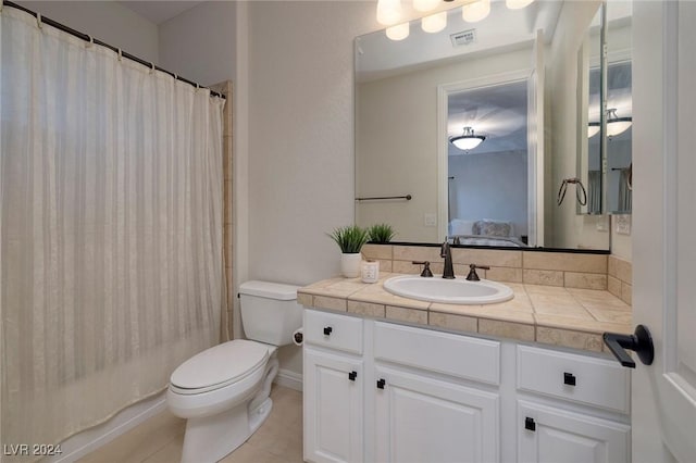 bathroom featuring tile patterned floors, vanity, and toilet