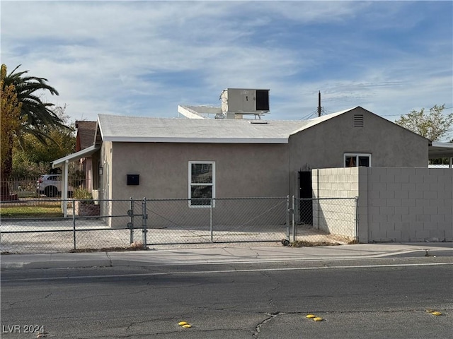 view of side of home with central air condition unit