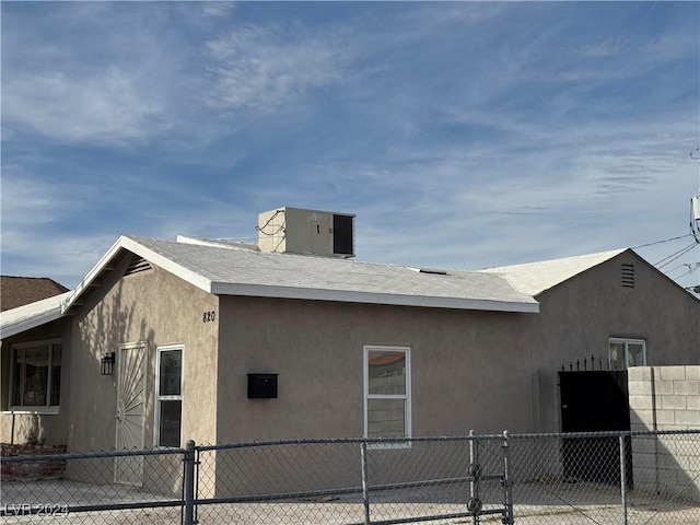 view of side of property with central air condition unit