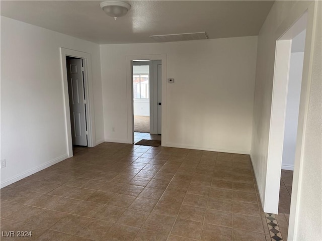 unfurnished room with tile patterned floors