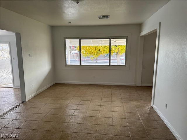 unfurnished room featuring light tile patterned floors