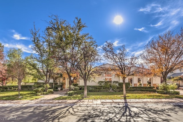 mediterranean / spanish-style home with a front yard