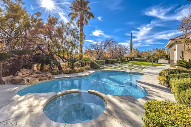 view of swimming pool featuring an in ground hot tub