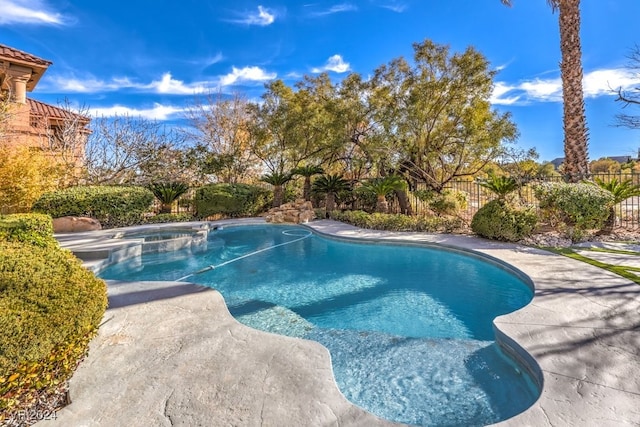 view of pool with an in ground hot tub