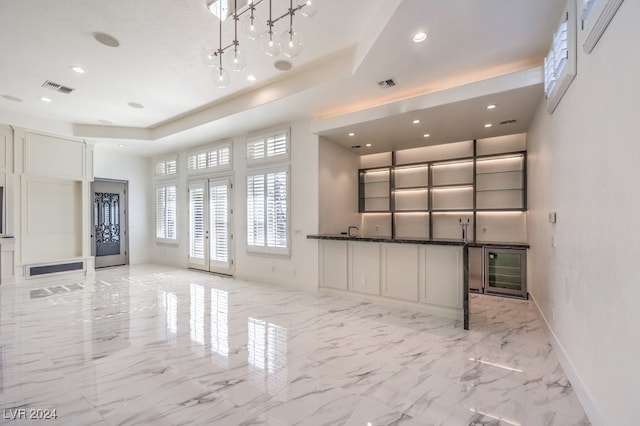 unfurnished living room featuring a tray ceiling