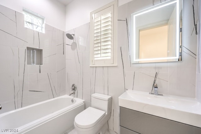 full bathroom featuring toilet, vanity, and tiled shower / bath