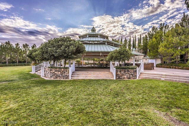 surrounding community with a gazebo and a yard