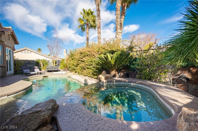 view of pool featuring a patio area and a hot tub