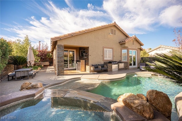 view of pool featuring an outdoor kitchen, a hot tub, a patio, and french doors