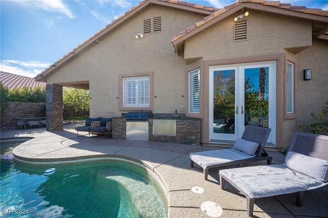 back of house with area for grilling, a patio, and french doors