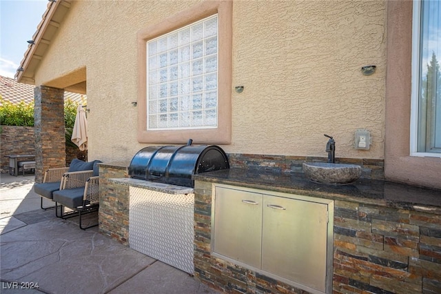 view of patio featuring exterior kitchen and sink