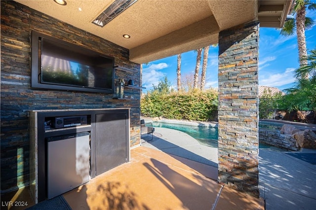 view of patio / terrace with a fenced in pool