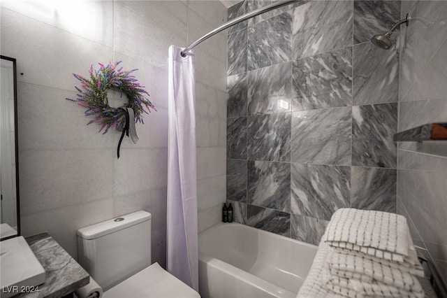 full bathroom with vanity, toilet, shower / bathtub combination with curtain, and tile walls