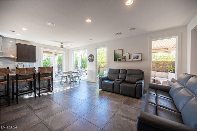 living room with ceiling fan and plenty of natural light