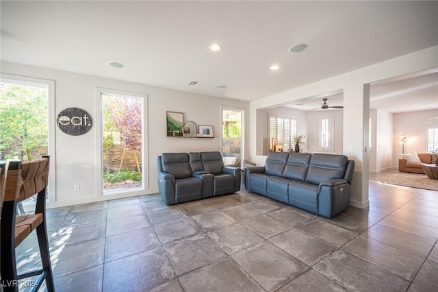 living room with ceiling fan and a healthy amount of sunlight