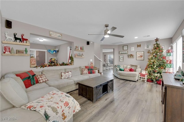 living room with ceiling fan and light hardwood / wood-style floors