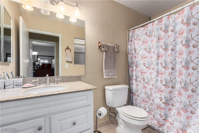 bathroom with curtained shower, tile patterned flooring, vanity, and toilet