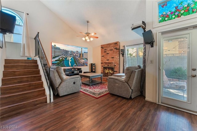 living room with dark hardwood / wood-style flooring, a brick fireplace, plenty of natural light, and ceiling fan