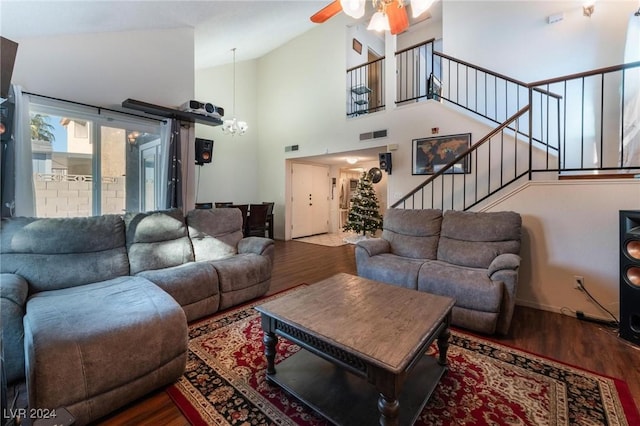 living room featuring hardwood / wood-style floors, high vaulted ceiling, and ceiling fan with notable chandelier