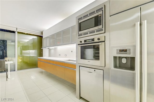 kitchen with built in appliances and light tile patterned flooring