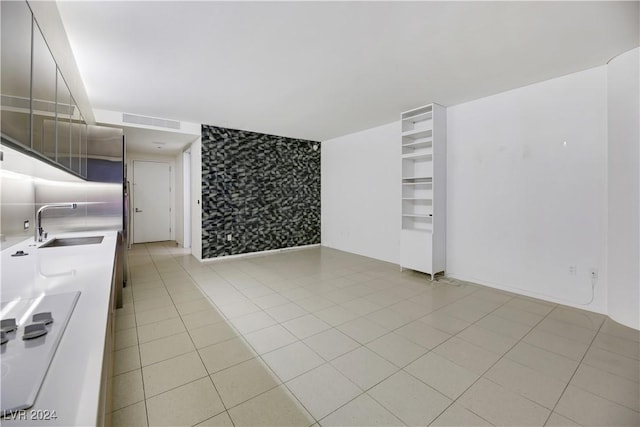 interior space featuring light tile patterned flooring and sink