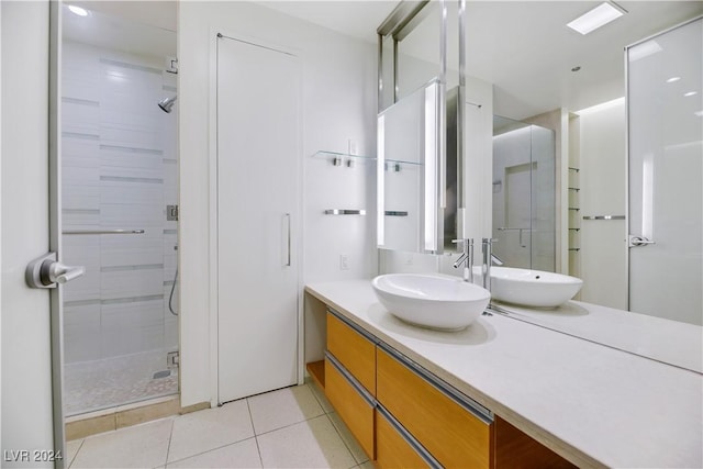 bathroom with tile patterned flooring, vanity, and a shower with shower door