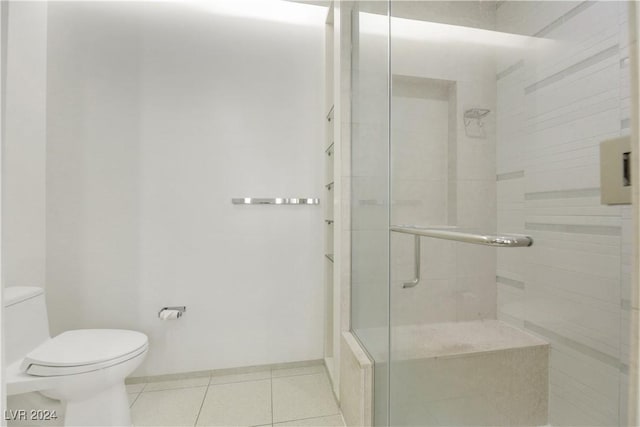 bathroom with tile patterned flooring, an enclosed shower, and toilet