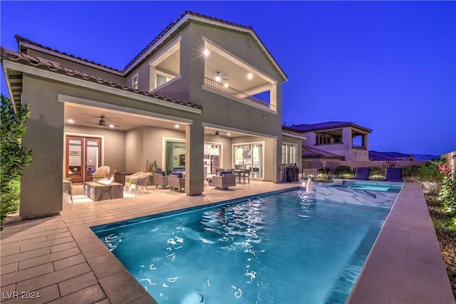 view of pool featuring an outdoor living space, ceiling fan, and a patio area