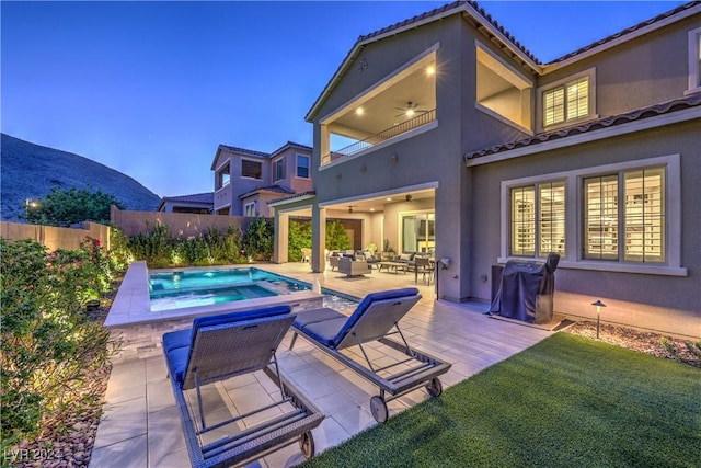 view of swimming pool with ceiling fan, an outdoor living space, a mountain view, an in ground hot tub, and a patio