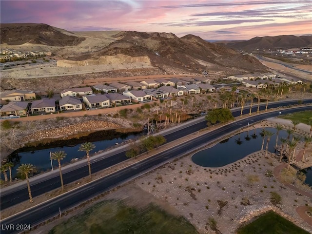 aerial view at dusk with a water and mountain view