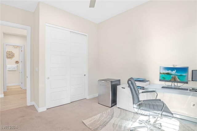 carpeted office featuring ceiling fan