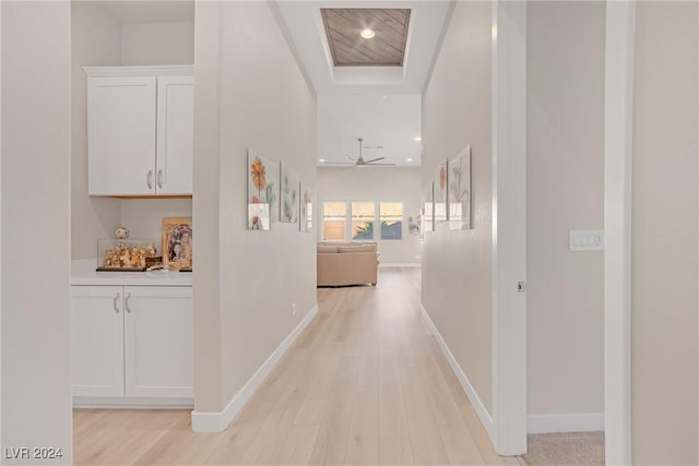 corridor with light hardwood / wood-style floors