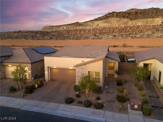 view of front of house with a garage and a mountain view