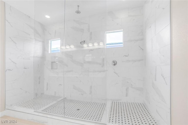 bathroom with an enclosed shower and a wealth of natural light