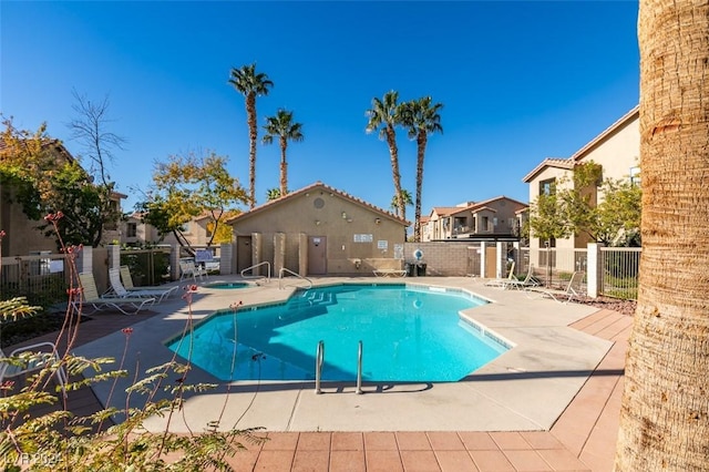 view of pool featuring a hot tub and a patio