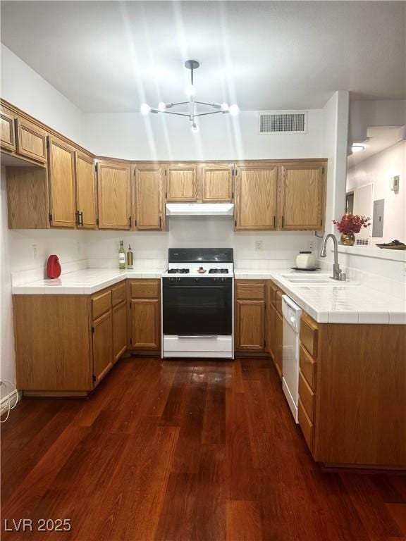 kitchen with sink, white appliances, electric panel, dark hardwood / wood-style floors, and kitchen peninsula