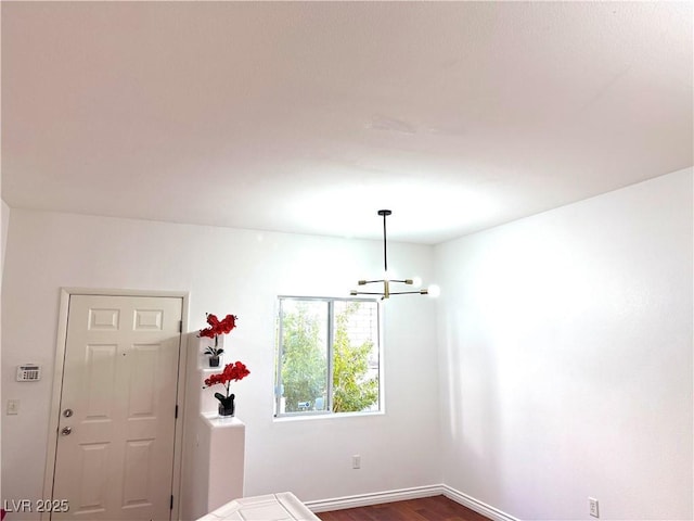 interior space with dark hardwood / wood-style flooring and a notable chandelier