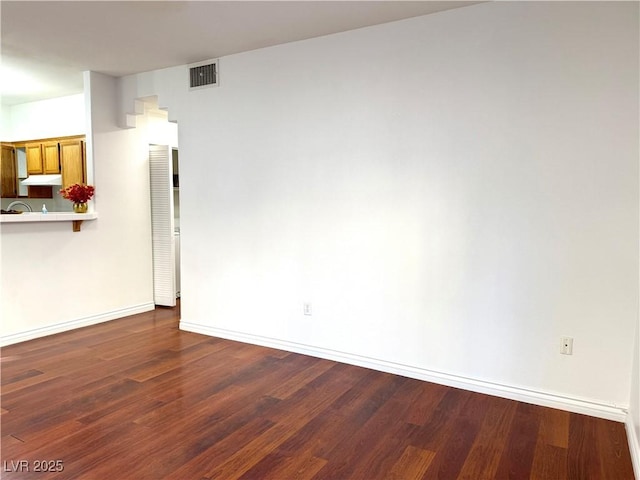 unfurnished room featuring dark hardwood / wood-style floors