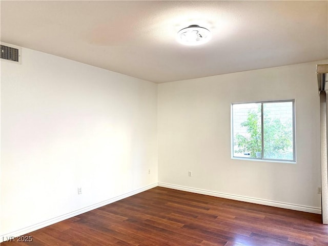 unfurnished room with dark hardwood / wood-style flooring