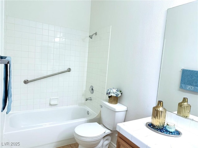 full bathroom with vanity, tiled shower / bath combo, and toilet