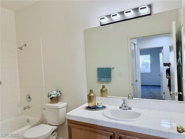 full bathroom with vanity, toilet, and tiled shower / bath combo