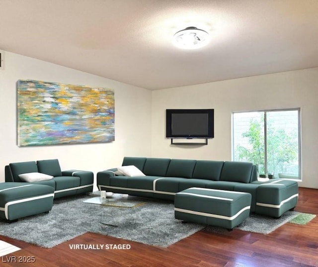 living room featuring wood-type flooring and vaulted ceiling