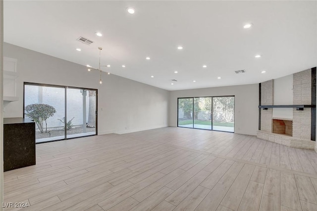 unfurnished living room with a fireplace and light hardwood / wood-style flooring