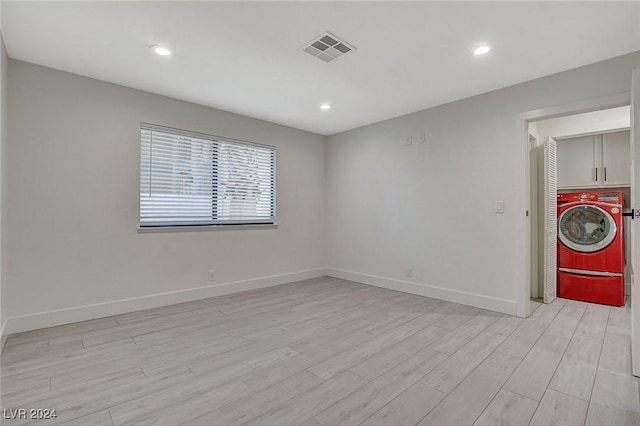 unfurnished room featuring light hardwood / wood-style floors and washer / dryer